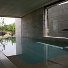 Design Of Pool Astonishing Design Of Stylish Lap Pool Indoor Space With Brick Wall Interior Glass Windows Design Blue Bottom Pool Design Dream Homes Spanish Home Design With Futuristic And Elegant Cantilevered Decorations