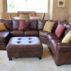 Traditional Family With Exciting Traditional Family Room Design With Dark Brown Colored Leather Sectional Sofa Several Pillows And Dark Brown Ottoman Table Decoration 20 Brilliant Leather Sectional Sofas That Will Fit Stunningly Into Your Family Home
