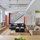 Living Room Sofas Eye Catching Living Room With Black Sofas Facing Twin Coffee Table Beside Bookcase Feat Planter And Under The Fun Light Decoration Dramatic Yet Elegant Bold Black Sofas For Exquisite Interior Decorations