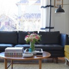 Eclectic Living Black Fabulous Eclectic Living Room With Black Sofas Facing Wooden Table Feat Flower Beside The Books And Ashtray Also Decoration Dramatic Yet Elegant Bold Black Sofas For Exquisite Interior Decorations