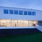 Green Turfs Of Fascinating Green Turfs In Front Of The House L Residence With Stone Patterned Around The Floor And White Painting Decoration Simple Home Design With Transparent Glass Wall And Bright Interiors