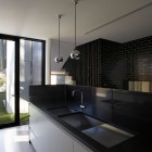 Dark Brick Modern Glossy Dark Brick Wall In Modern Luff Residence Metallic Ball Pendant Lights Black And White Kitchen Corner Glass Door In Dark Frame Architecture Astonishing Contemporary Concrete Home With Minimalist Interior Features