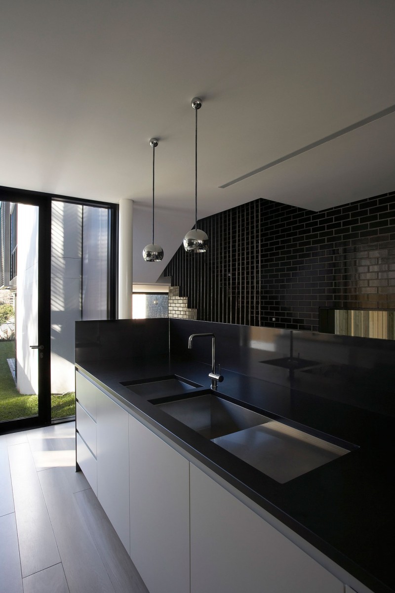 Dark Brick Modern Glossy Dark Brick Wall In Modern Luff Residence Metallic Ball Pendant Lights Black And White Kitchen Corner Glass Door In Dark Frame Architecture  Astonishing Contemporary Concrete Home With Minimalist Interior Features