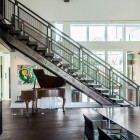 Brown Painted Placed Gorgeous Brown Painted Grand Piano Placed Under Wooden Stairs In Park City Residence Jaffa Group Dream Homes Captivating Home Design With Grey Exterior Surrounded By Green Lawn