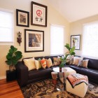 Living Room Sofas Interesting Living Room With Black Sofas Feat Nice Pillows Under Photos And Planters Giving Fresh Atmosphere In The Area Decoration Dramatic Yet Elegant Bold Black Sofas For Exquisite Interior Decorations