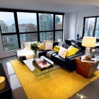 Living Room Carpet Magnificent Living Room With Yellow Carpet And Black Sofas Feat Nice Pillows That Glass Windows Showing Outside View Decoration Dramatic Yet Elegant Bold Black Sofas For Exquisite Interior Decorations