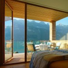 Bedroom Design Am Marvelous Bedroom Design Of Wohnhaus Am Walensee Residence With Brown Bed Linen Blue Blanket And Transparent Wall Made From Glass Panel Architecture Beautiful Rectangular Lake Home With Wood And Concrete Elements