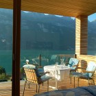 Balcony Design Am Mesmerizing Balcony Design Of Wohnhaus Am Walensee Residence With Soft Blue Colored Chairs And Round Surface Wooden Table With White Color Architecture Beautiful Rectangular Lake Home With Wood And Concrete Elements