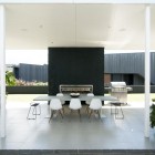 Taumata House With Open Taumata House Dining Space With A Set Of White Painted Table And Chairs Set With Black Fireplace As Background Dream Homes Natural Minimalist Home In Contemporary And Beautiful Decorations