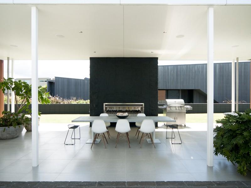 Taumata House With Open Taumata House Dining Space With A Set Of White Painted Table And Chairs Set With Black Fireplace As Background Dream Homes  Natural Minimalist Home In Contemporary And Beautiful Decorations