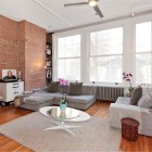 Brick Wall Oval Rustic Brick Wall Wood Floor Oval Coffee Table Grey Apartment Sofa Beautiful Flowers Sparkling Ceiling Light Small White Cabinet Decoration Lovely Beautiful Sofa Ideas For Creative Apartment Appearance