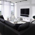 Living Room Sofas Sleek Living Room With Black Sofas Facing Glass Table And Black Led TV Beside Sheer Curtain Design Decoration Dramatic Yet Elegant Bold Black Sofas For Exquisite Interior Decorations