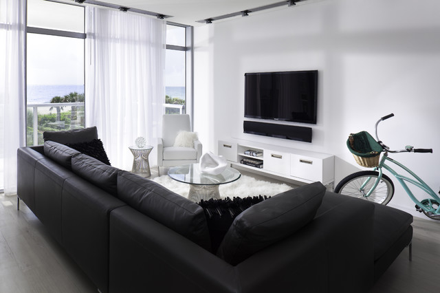 Living Room Sofas Sleek Living Room With Black Sofas Facing Glass Table And Black Led TV Beside Sheer Curtain Design Decoration Dramatic Yet Elegant Bold Black Sofas For Exquisite Interior Decorations