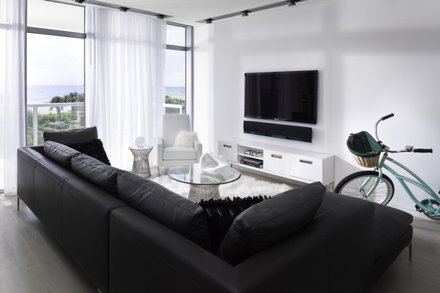 Living Room Sofas Sleek Living Room With Black Sofas Facing Glass Table And Black Led TV Beside Sheer Curtain Design Decoration  Dramatic Yet Elegant Bold Black Sofas For Exquisite Interior Decorations