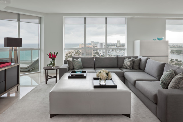 Living Room Sofas Sleek Living Room With Grey Sofas Facing White Coffee Table Feat Flower And The Glass Wall Showing Outside View Decoration Fashionable And Modern Grey Sofas For White Interior Colors