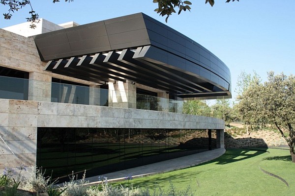 Style Of Spanish Smart Style Of Curved Structure Spanish Home Clad In Stone Wall Construction With Glass Facades And Fences In Two Story House  Spanish Home Design With Futuristic And Elegant Cantilevered Decorations
