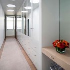 Walk In The Stunning Walk In Closet Inside The Modern Family Residence With White Drawers And White Cabinets Near Mirrored Doors Dream Homes Duplex Contemporary Concrete Home With Outdoor Green Gardens For Family