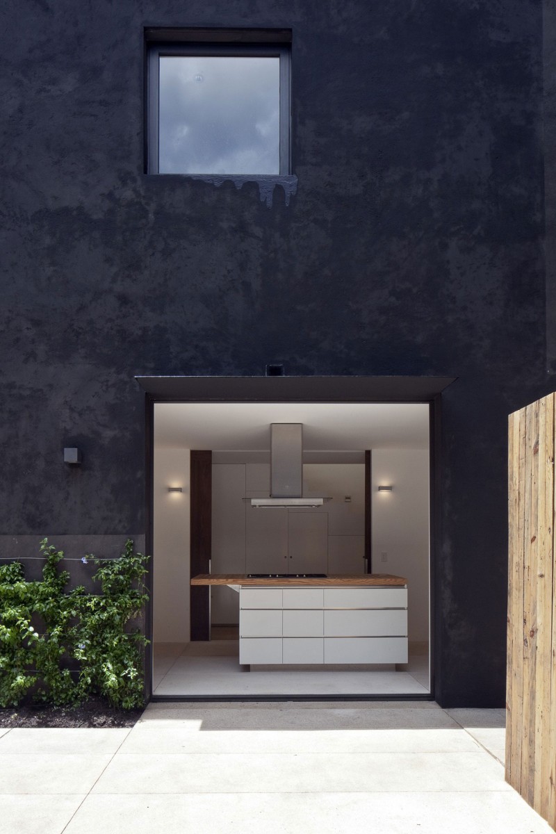 White Open In Stunning White Open Plan Kitchen In Cerrada Reforma 108 With Dark Outdoor Wall Small Glass Window Dark Cantilever Ornamental Plants Architecture Dramatic Home Decoration With Black Painted Exterior Walls