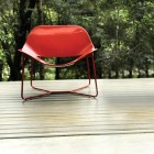 Red Lacquered On Vibrant Red Lacquered Chair Put On Home Deck As Furnishing While Enjoying The Lush Greenery Outside Of The House Furniture Beautiful Lacquer Furniture With Hip And Glossy Surface