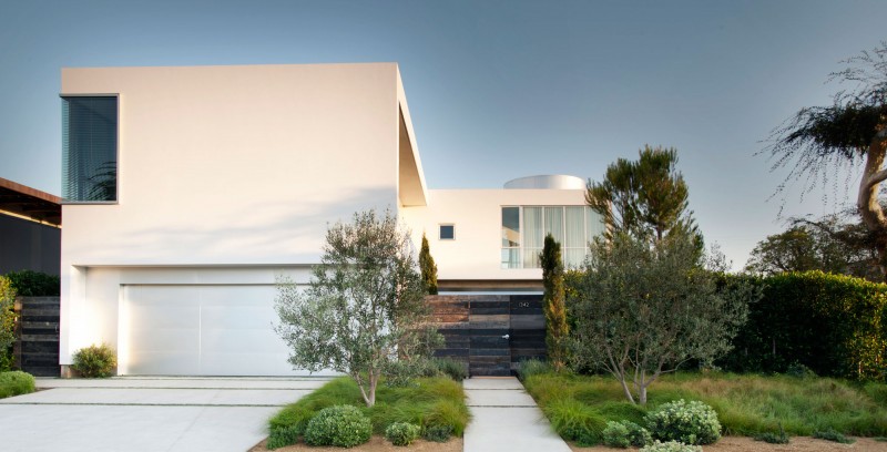 White Garage Modern Wide White Garage Door In Modern Family Residence Facade With Grey Gate And White Wall Near Green Plantations Dream Homes  Duplex Contemporary Concrete Home With Outdoor Green Gardens For Family