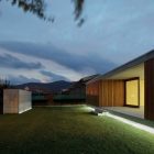 Lighting From In Bright Lighting From The House In Villarcaya With Concrete Terrace And Green Grass Yard Near Wooden Wall Architecture Chic Spanish Home Design With Grey Concrete Floors