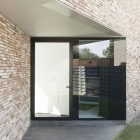 House K Modern Imposing House K Exterior With Modern Glass Door On Corner Dark Concrete Floor Rough Brick Wall Grassy Yard Dream Homes Stunning Contemporary House With Bright Black And White Colors