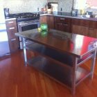 Wooden Counter Countertop Stylish Wooden Counter And Glossy Countertop Near Stainless Steel Kitchen Tables On Oak Flooring Kitchens Effective Stainless Steel Kitchen Tables For Commercial Kitchen