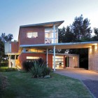 Evm House Brick Attractive EVM House Exterior With Brick Wall Ornamental Plants On Spacious Courtyard Large Glass Window Sparkling Outdoor Lights Dream Homes Impressive Orange House For Stunning Modern Living Place