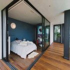 Bedroom With Door Cozy Bedroom With Sliding Glass Door White Bed Rustic Wood Floor Scenic Painting Small Balcony With Metallic Railing In Green Greenberg Green House Architecture Curvy Futuristic Home Presenting Futuristic Gray And White Themes