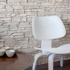Stone Tiled As Natural Stone Tiled Wall Installed As Center Wall Of Apartment On The Waterfront Seating Area With Tray Table And Chair Apartments Scandinavian Interior Design With Minimalist Round Dining Table