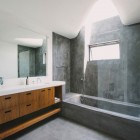 Concrete Wall Bathroom Tough Concrete Wall Lacquered Wood Bathroom Vanity With White Sink Rectangular Mirror Glass Wall Stainless Steel Shower In Green Greenberg Green House Architecture Curvy Futuristic Home Presenting Futuristic Gray And White Themes