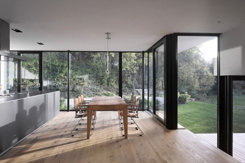 View By Design Warm View By Kitchen Table Design With Wooden Table And Chairs Under The Pendant Lamps At The Zochental Residence Architecture Creative Glass Facade Of Unconventional Contemporary House Appearance