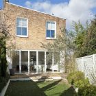 A Crisp Exterior Amazing A Crisp White Home Exterior Glass Door Precious Ornamental Plants Rustic Brick Wall Open Plan Interior Apartments Luminous And White Scandinavian Home With Exposed Eclectic Brick Facade