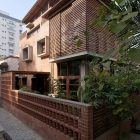 Green House Wood Appealing Green House Exterior With Wood Wall Cladding Artistic Brick Fence Ornamental Plants Square Glass Window Interior Design Eco-Friendly Modern Green Home With Exposed Red Brick Walls