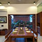 Painting Rectangular Table Artistic Painting Rectangular Wood Dining Table With Asian Tabletop Glaring Ceiling Lights Homey Green House Scenic Statue Interior Design Eco-Friendly Modern Green Home With Exposed Red Brick Walls