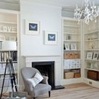 Crystal Chandelier Crisp Awesome Crystal Chandelier In A Crisp White Home Classic Fireplace Large Bookcase Wood Floor Rattan Baskets Butterfly Painting Apartments Luminous And White Scandinavian Home With Exposed Eclectic Brick Facade