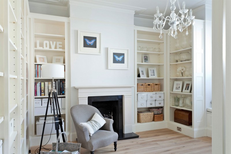 Crystal Chandelier Crisp Awesome Crystal Chandelier In A Crisp White Home Classic Fireplace Large Bookcase Wood Floor Rattan Baskets Butterfly Painting Apartments Luminous And White Scandinavian Home With Exposed Eclectic Brick Facade