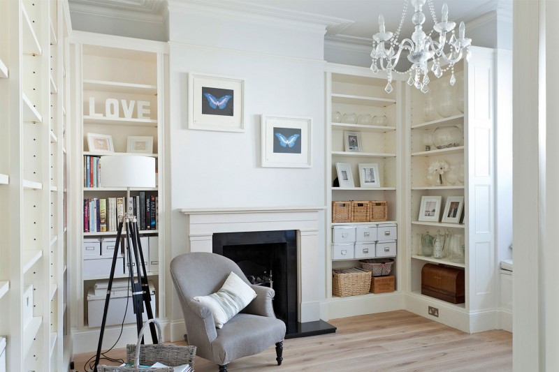 Crystal Chandelier Crisp Awesome Crystal Chandelier In A Crisp White Home Classic Fireplace Large Bookcase Wood Floor Rattan Baskets Butterfly Painting Apartments  Luminous And White Scandinavian Home With Exposed Eclectic Brick Facade