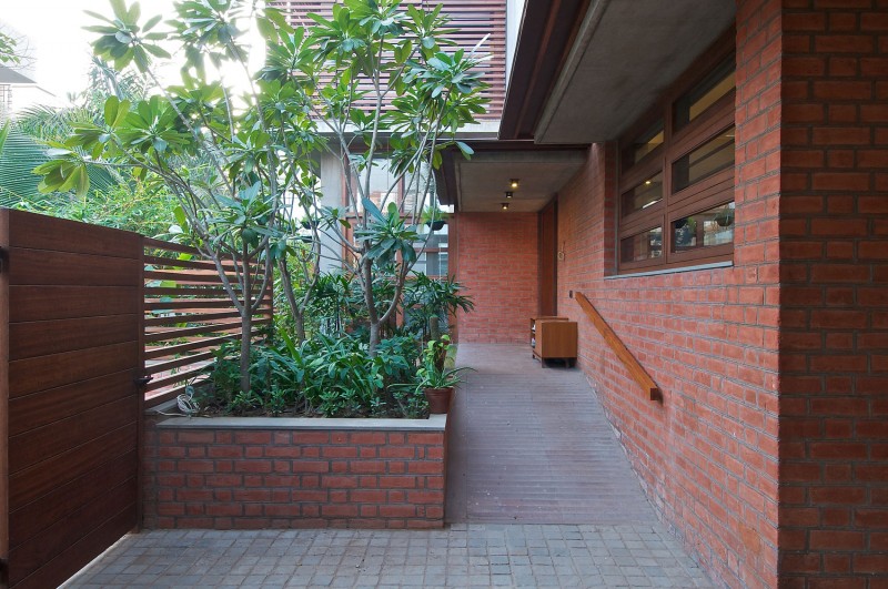 Ornamental Plants Flower Beautiful Ornamental Plants In Rectangular Flower Bed In Green House Rustic Brick Wall Shiny Outdoor Light Traditional Wood Gate Interior Design Eco-Friendly Modern Green Home With Exposed Red Brick Walls