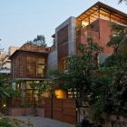 Green House Cladding Exotic Green House With Wood Cladding Wall Peaceful Ornamental Plants Concrete Front Yard Soft Outdoor Lights Modern Wood Gate Interior Design Eco-Friendly Modern Green Home With Exposed Red Brick Walls