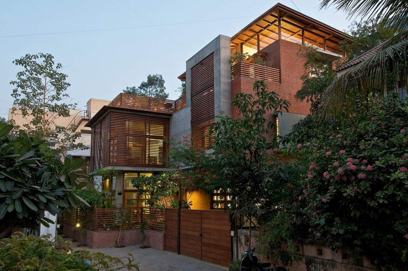 Green House Cladding Exotic Green House With Wood Cladding Wall Peaceful Ornamental Plants Concrete Front Yard Soft Outdoor Lights Modern Wood Gate Interior Design  Eco-Friendly Modern Green Home With Exposed Red Brick Walls