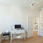 Crystal Chandelier Crisp Glamorous Crystal Chandelier In A Crisp White Home Large White Bookcase Small Computer Desk And Acrylic Chair Warm Wood Floor Apartments Luminous And White Scandinavian Home With Exposed Eclectic Brick Facade