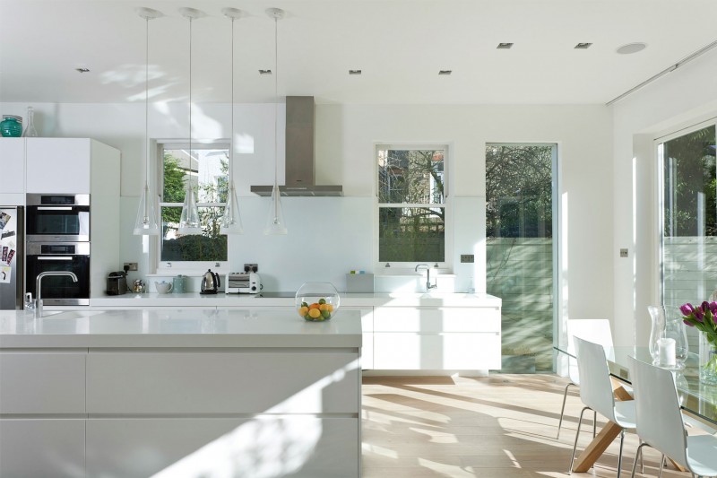 A Crisp With Lavish A Crisp White Home With Clean White Kitchen Island And Modern Kitchen Appliances Glass Dining Table And White Acrylic Chairs Apartments Luminous And White Scandinavian Home With Exposed Eclectic Brick Facade