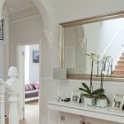 A Crisp Interior Pleasant A Crisp White Home Interior With Arched Door Rectangular Mirror In Silver Frame Nice Ornaments On Console Table Apartments Luminous And White Scandinavian Home With Exposed Eclectic Brick Facade
