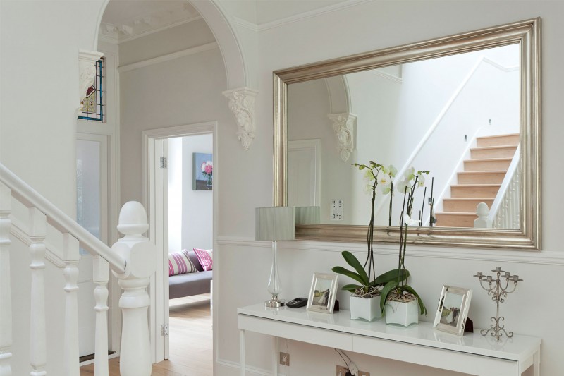 A Crisp Interior Pleasant A Crisp White Home Interior With Arched Door Rectangular Mirror In Silver Frame Nice Ornaments On Console Table Apartments Luminous And White Scandinavian Home With Exposed Eclectic Brick Facade