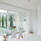 Glass Dining White Rectangular Glass Dining Table And White Acrylic Chairs Bright Pendant Lights Contemporary Gas Fireplace Wood Floor Apartments Luminous And White Scandinavian Home With Exposed Eclectic Brick Facade