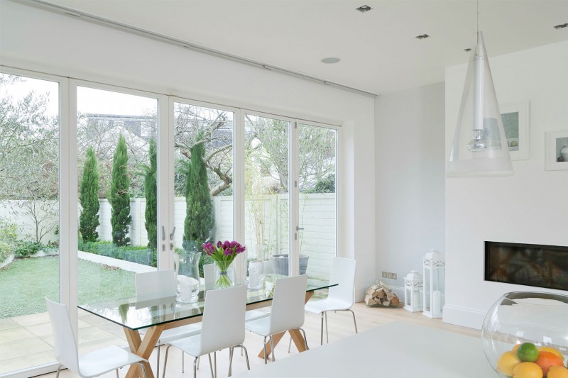 Glass Dining White Rectangular Glass Dining Table And White Acrylic Chairs Bright Pendant Lights Contemporary Gas Fireplace Wood Floor Apartments Luminous And White Scandinavian Home With Exposed Eclectic Brick Facade