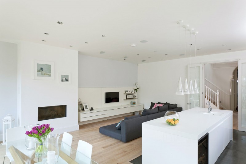 Wood Floor Sofa Rustic Wood Floor Dark Bed Sofa Floating TV Stand Modern Gas Fireplace Glass Pendant Lights White Kitchen Island In A Crisp White Home Apartments Luminous And White Scandinavian Home With Exposed Eclectic Brick Facade