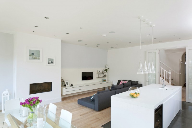 Wood Floor Sofa Rustic Wood Floor Dark Bed Sofa Floating TV Stand Modern Gas Fireplace Glass Pendant Lights White Kitchen Island In A Crisp White Home Apartments  Luminous And White Scandinavian Home With Exposed Eclectic Brick Facade