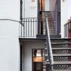 Dark Staircase Railing Antique Dark Staircase With Metallic Railing White Brick Wall Modern Wall Light Geometric Staircase In Lorber Tarler House Dream Homes Old House Turned Into A Stylish Modern Residence For Urban Dwelling